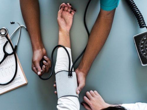 nurse taking patient blood pressure