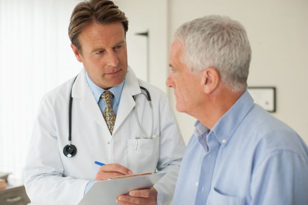 Male doctor advising older male patient